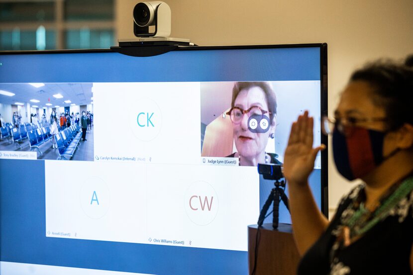 Lynn (center, on screen) virtually administers the oath of citizenship.