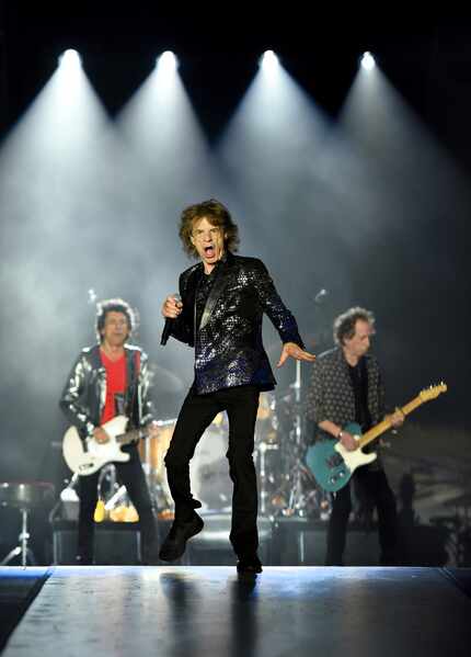 The Rolling Stones' lead vocalist Mick Jagger performs flanked by bandmates Ronnie Wood,...