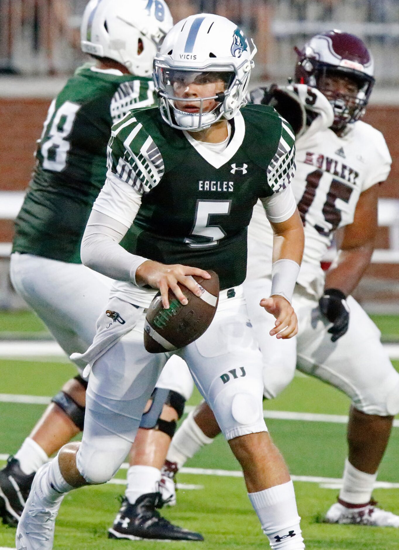 Prosper High School quarterback Berry Jackson (5) scrambles during the first half as Prosper...