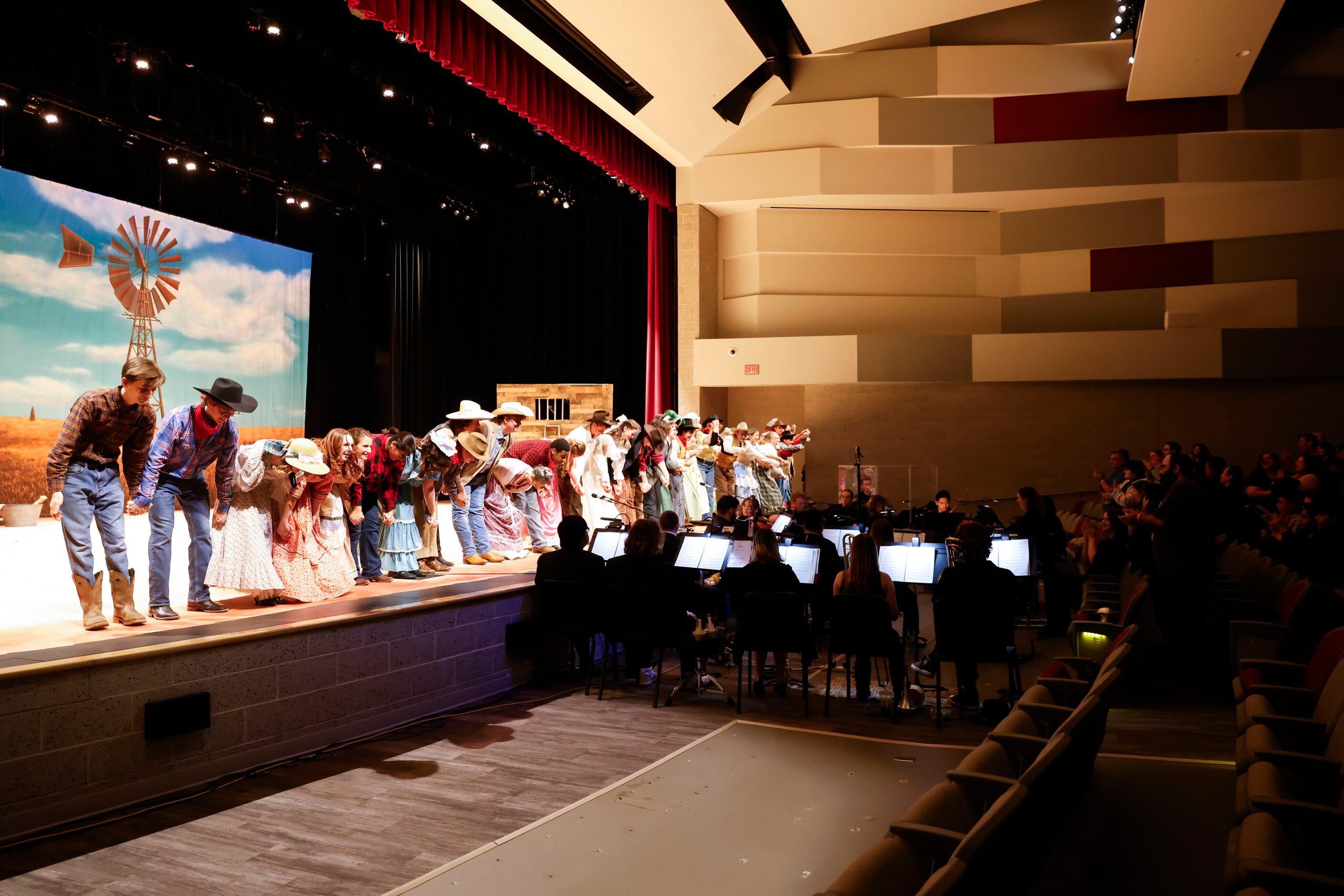 Cast members take a bow after the opening night of the Sherman High School production of...