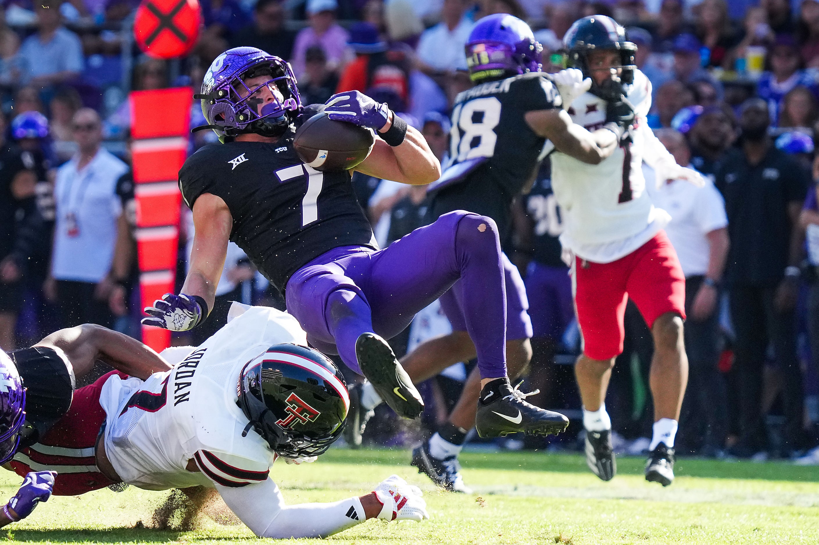 TCU wide receiver JP Richardson (7) is knocked off his feat by Texas Tech defensive back...