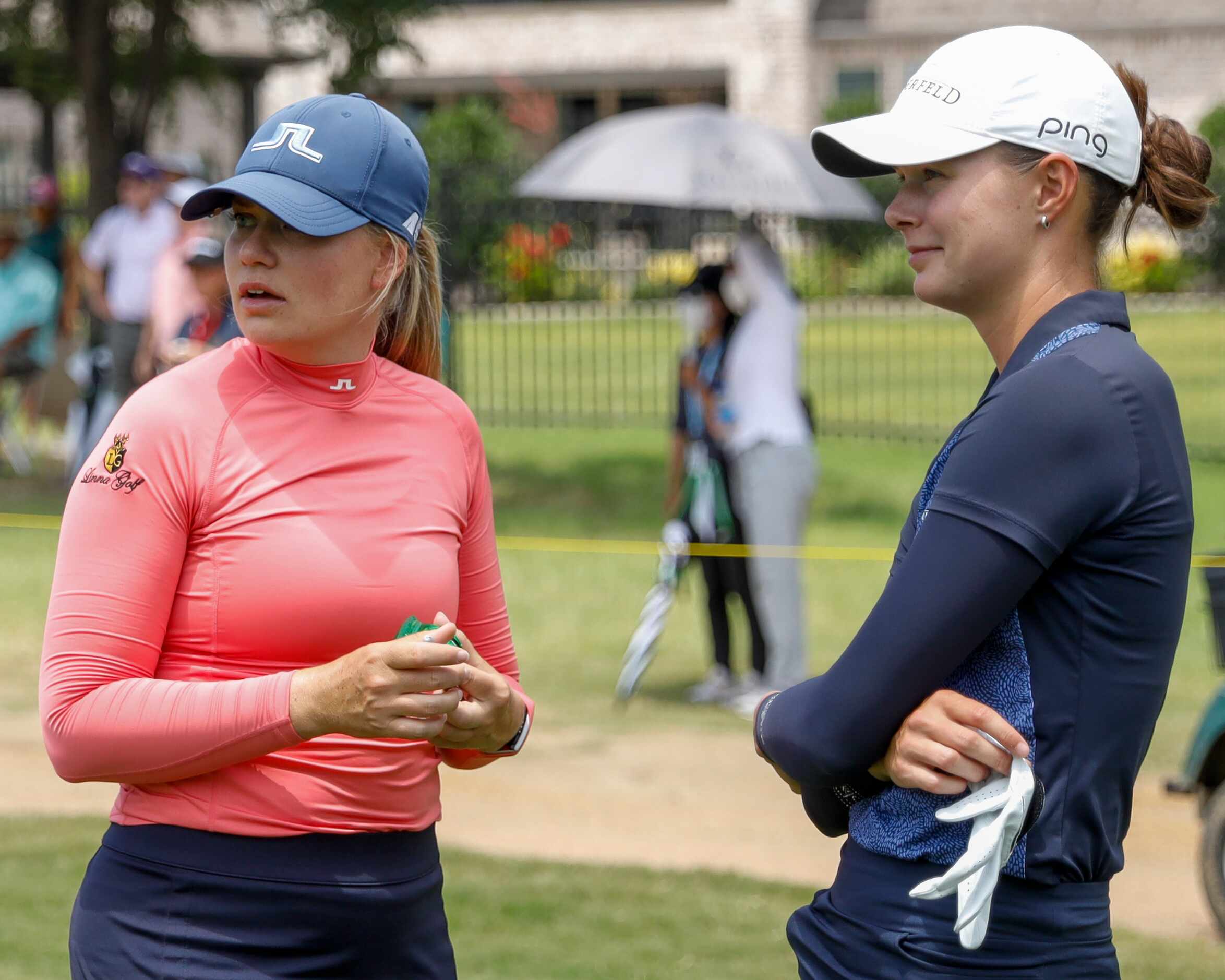 Professional golfers Matilda Castren (left) and Esther Henseleit chat after completing the...