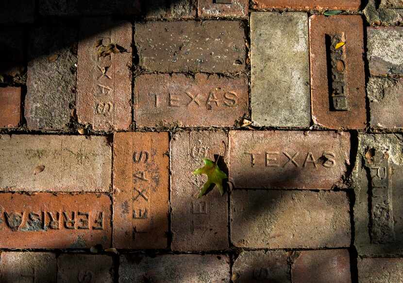 
Old bricks from the original chimneys of the home line an outdoor dining area in their...