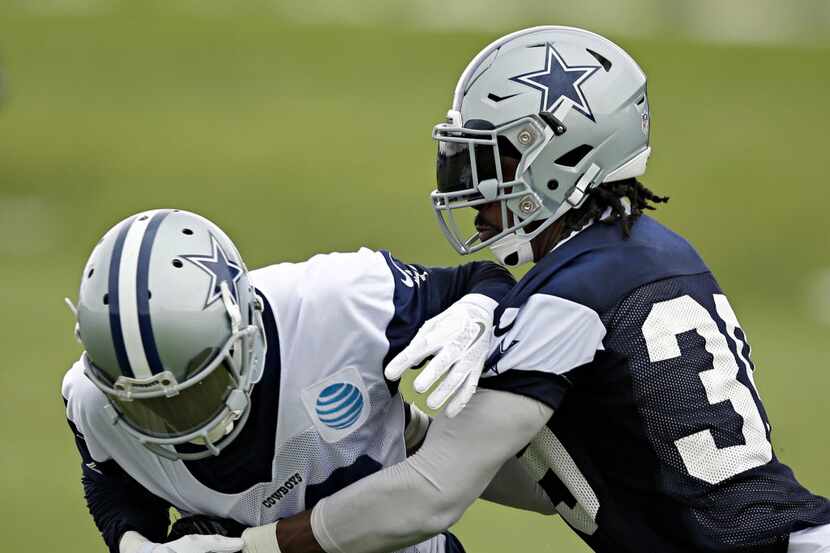 Dallas Cowboys cornerback Brandon Carr (right) strips the ball from wide receiver Terrance...