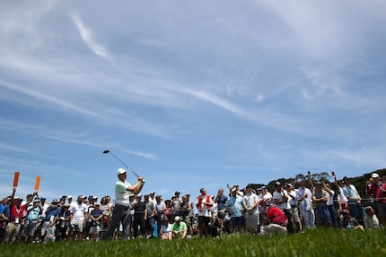 PEBBLE BEACH, CALIFORNIA - JUNE 10: Jordan Spieth plays a shot from the ninth tee as fans...