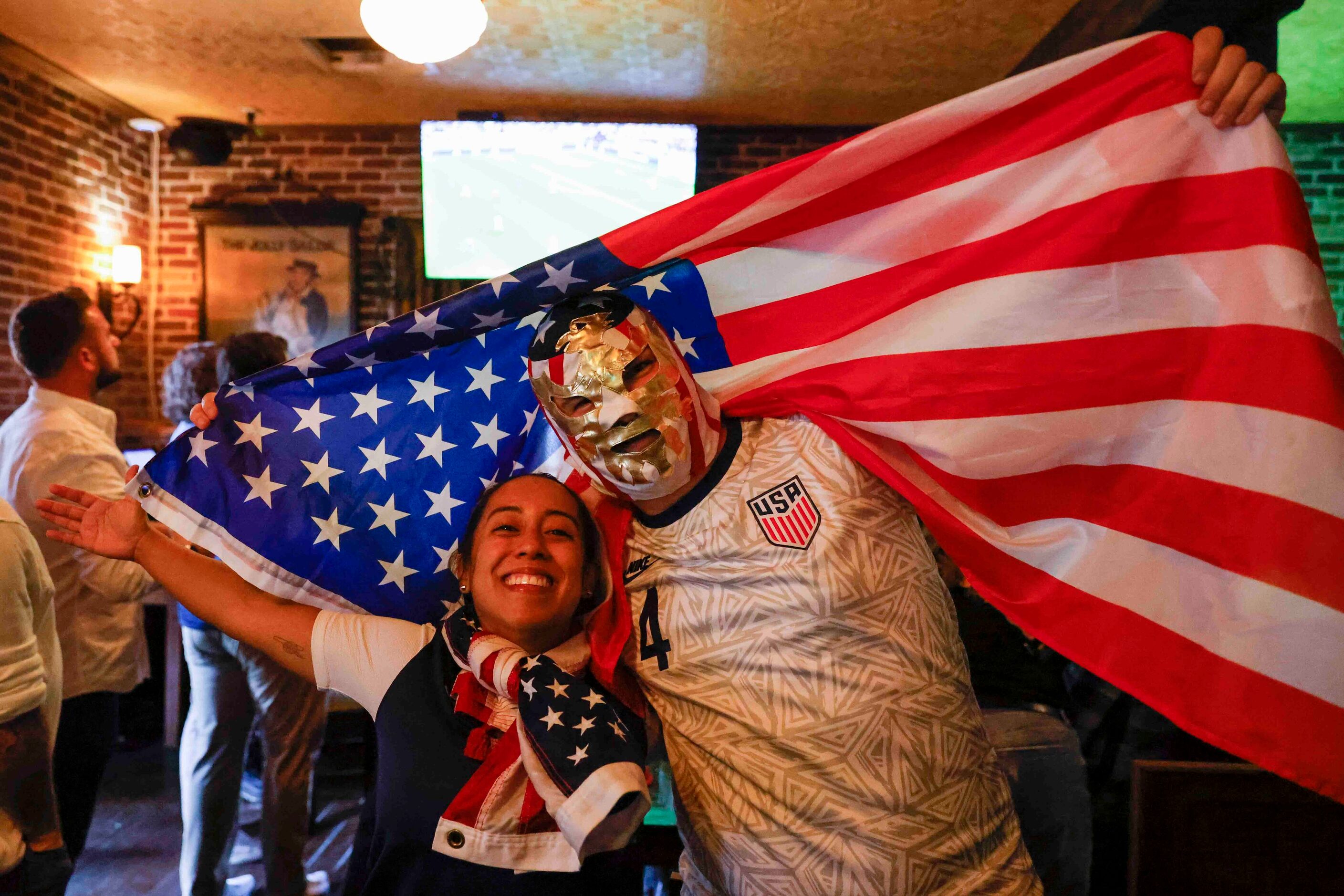 Irma Fernandez and Wilson Look, pose for a photo as they cheer for USA during a World Cup...