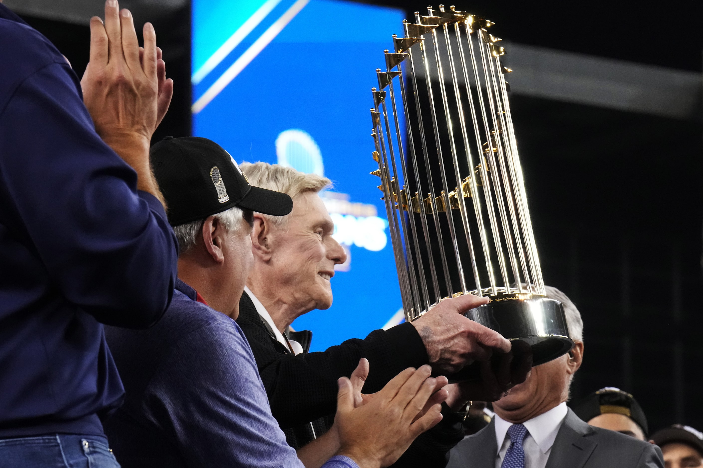 Texas Rangers owner Ray Davis is presented with the Commissioner’s Trophy after winning the...