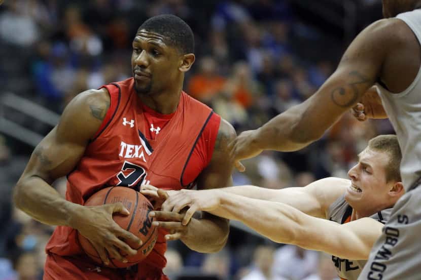 Texas Tech forward Jordan Tolbert, left, is covered by Oklahoma State guard Phil Forte, III,...
