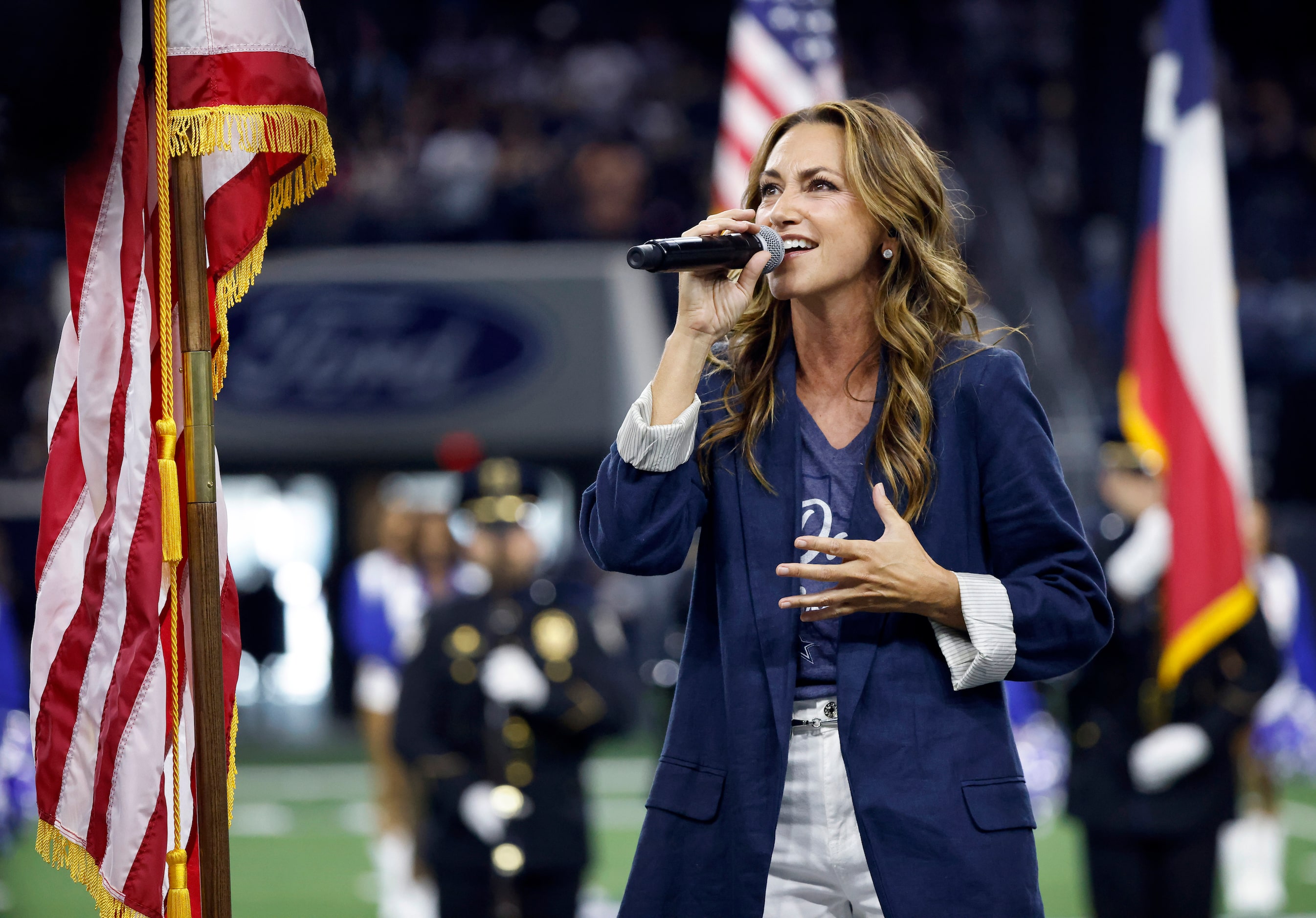 Celena Rae sings the national anthem during the Season Kickoff training camp practice at The...