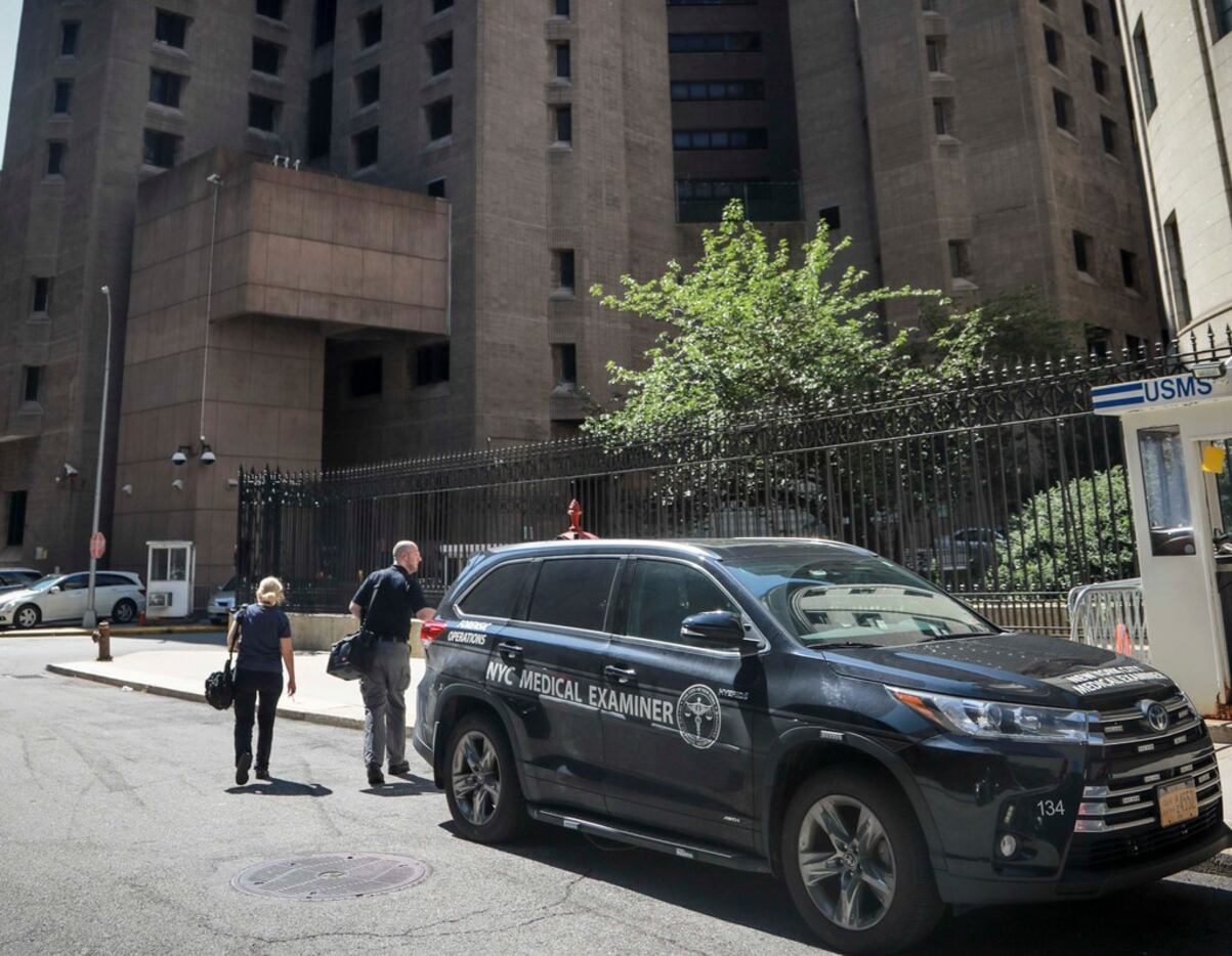 New York City medical examiner personnel leave their vehicle and walk to the Manhattan...