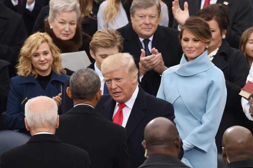 US President elect Donald Trump (C)salutes Us President Barrack Obama (back) as he arrives...