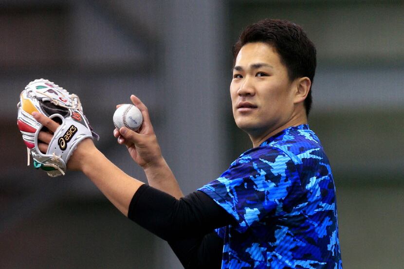 Japanese professional baseball pitcher Masahiro Tanaka of Rakuten Eagles hurls the ball...