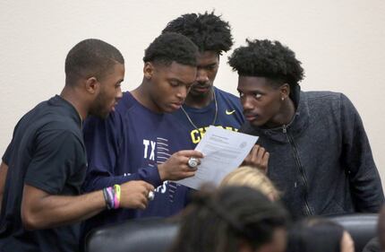 Defending state champion DeSoto Eagles football players, left to right, Byron Hanspard Jr.,...