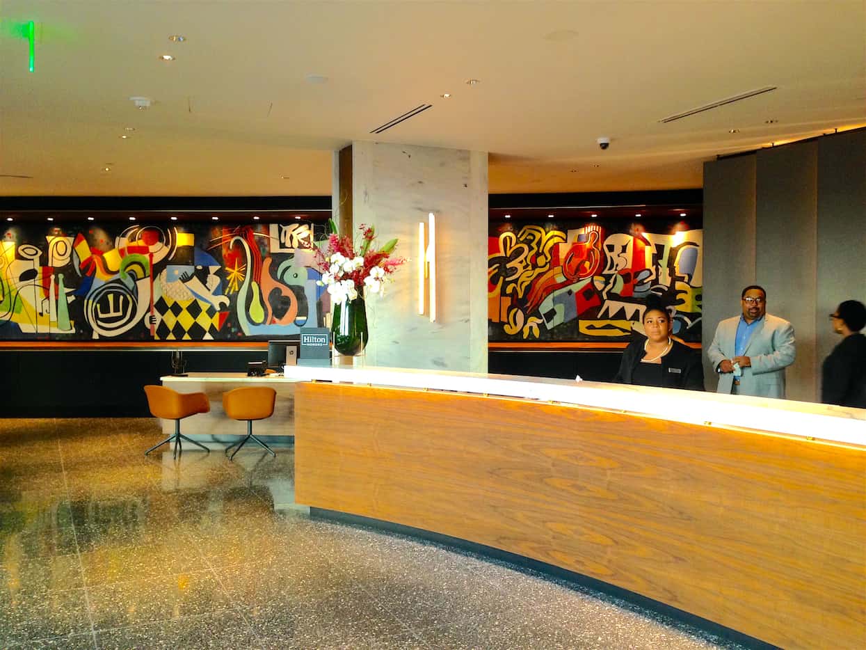 The Statler Hotel front desk showcases a restored midcentury mural by New York artist Jack...