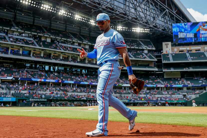 Texas Rangers second baseman Andy Ibanez (77) walks back to the dugout before the final game...