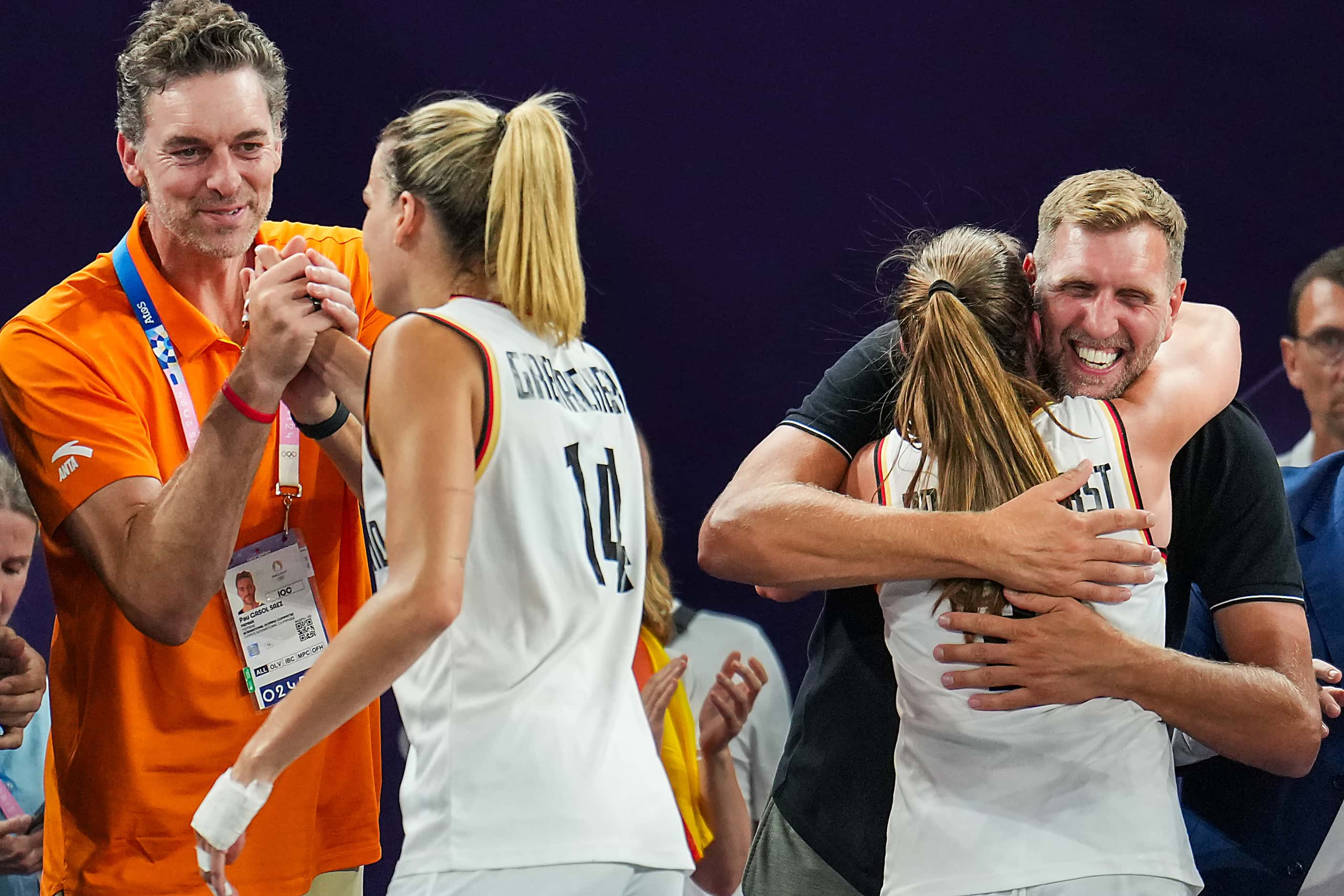 Dallas Mavericks great Dirk Nowitzki hugs Germany’s Svenja Brunckhorst (21) as Sonja...