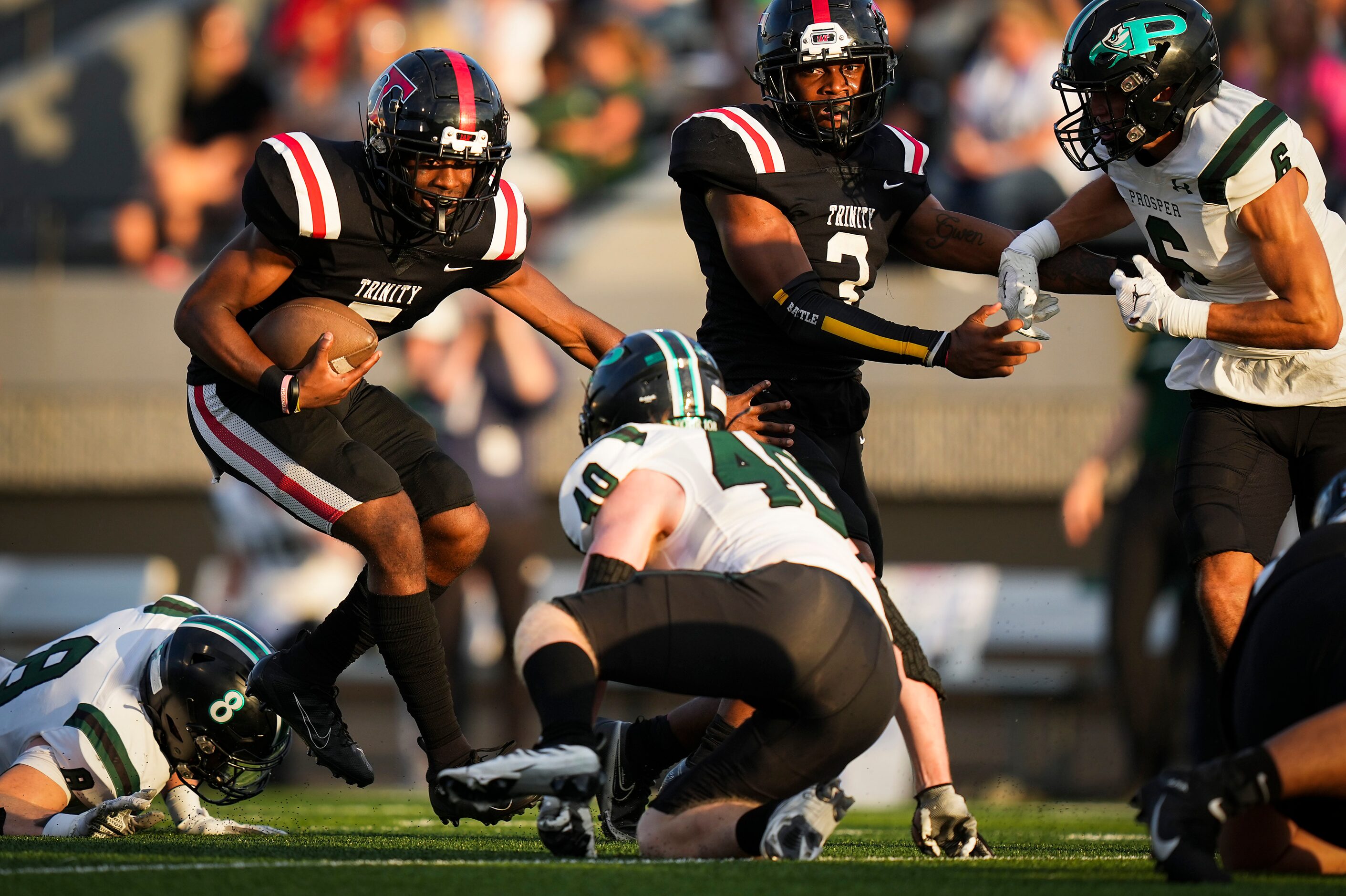 Euless Trinity quarterback Ethan Williams (5) gets past Prosper defender Jackson Forte (40)...