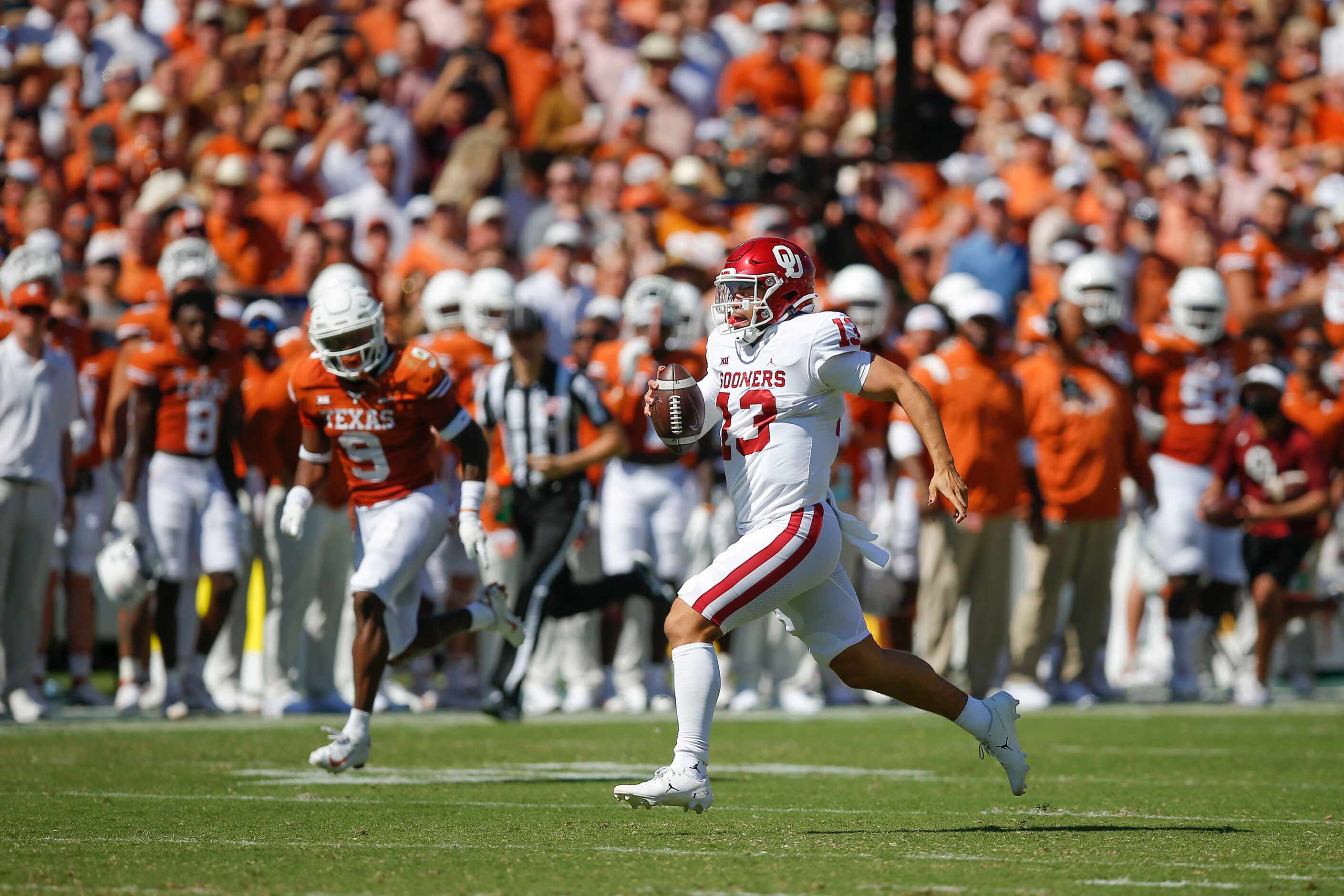 Oklahoma quarterback Caleb Williams (13) breaks past the Texas defense to score a touchdown...