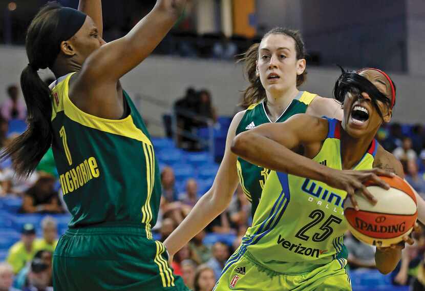 Dallas Wings forward Glory Johnson (right) tries to get around Seattle Storm forward Crystal...
