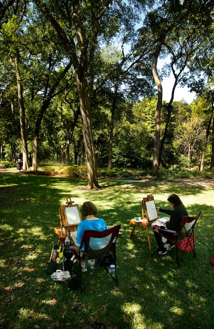 Girlfriends Joyce Mitchell (left) and Bobbi Banner paint watercolors of the woods lining...