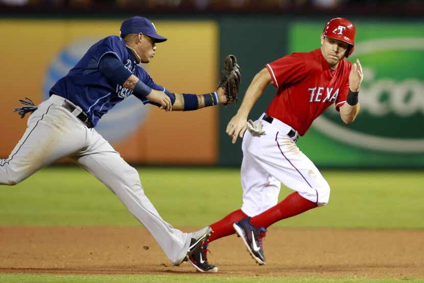 Sep 30, 2013; Arlington, TX, USA; Texas Rangers second baseman Ian Kinsler (right) is tagged...