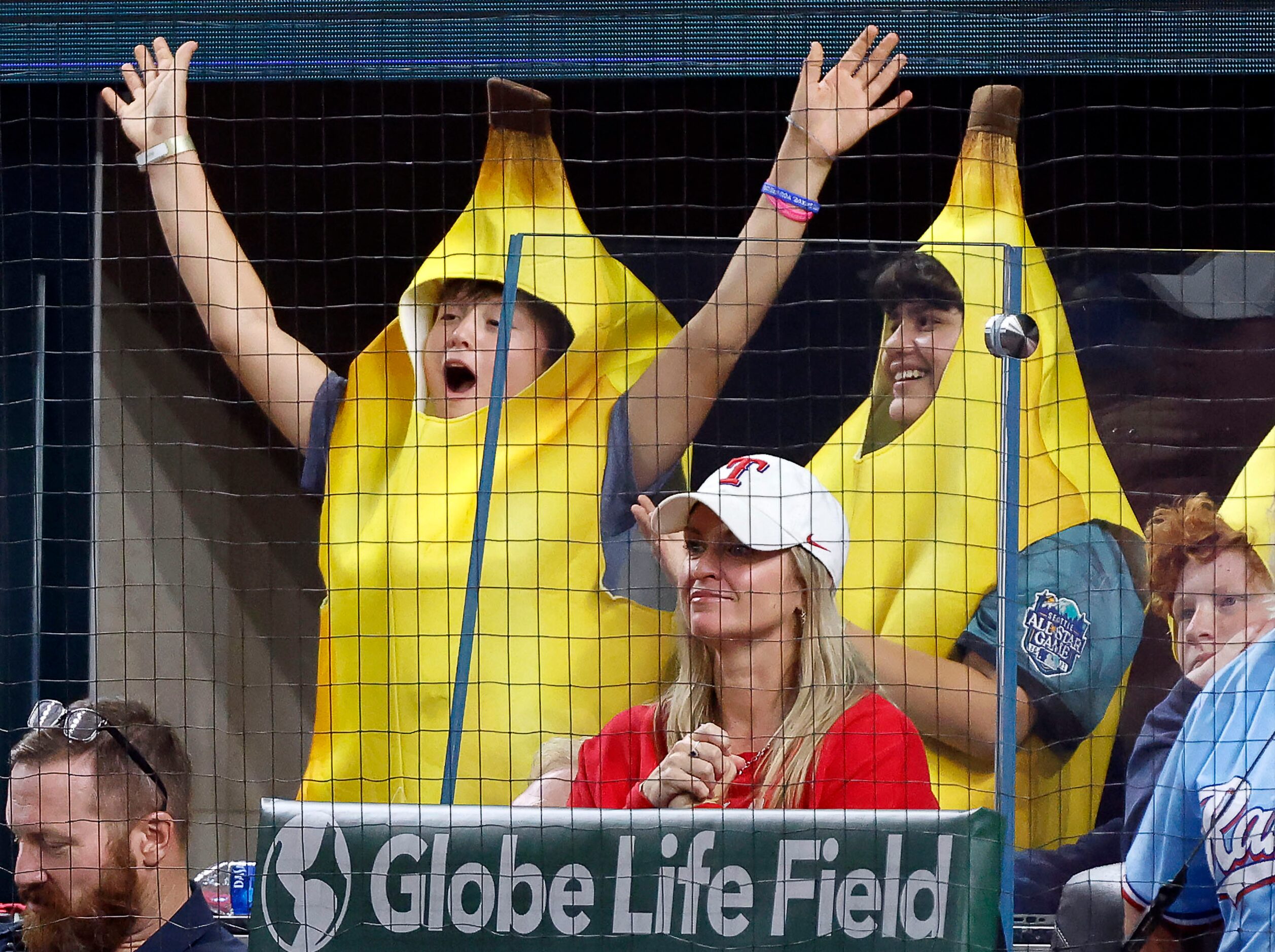 Kids dressed as bananas wave at the cameras from behind home plate during the first inning...