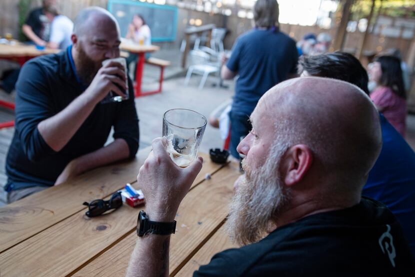 Justin Shelley (right) and Joe Melot enjoyed a beer on the patio at Dan's Silverleaf bar in...