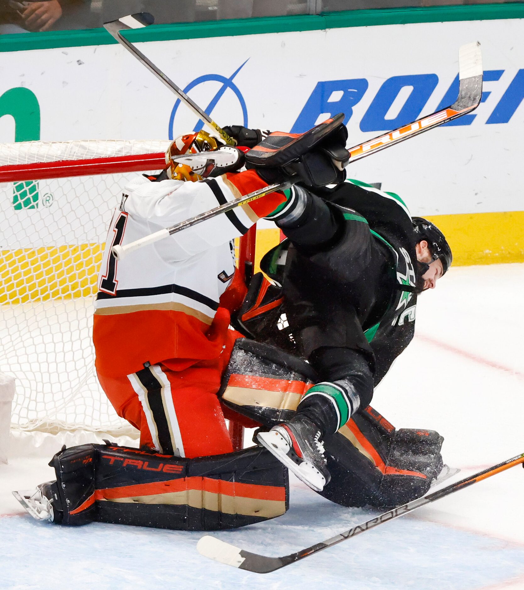 Dallas Stars left wing Jamie Benn (14) collides with Anaheim Ducks goaltender Anthony...