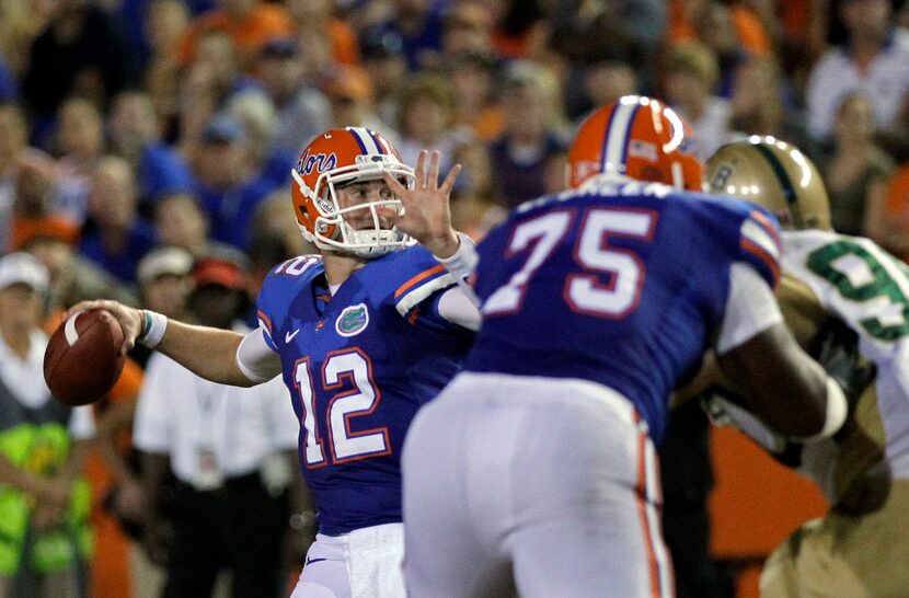 Florida quarterback John Brantley (12) throws a pass as offensive tackle Chaz Green (75)...