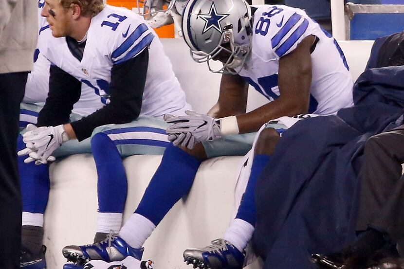 Dallas Cowboys wide receiver Dez Bryant (88) hangs his head as he sits on the bench next to...