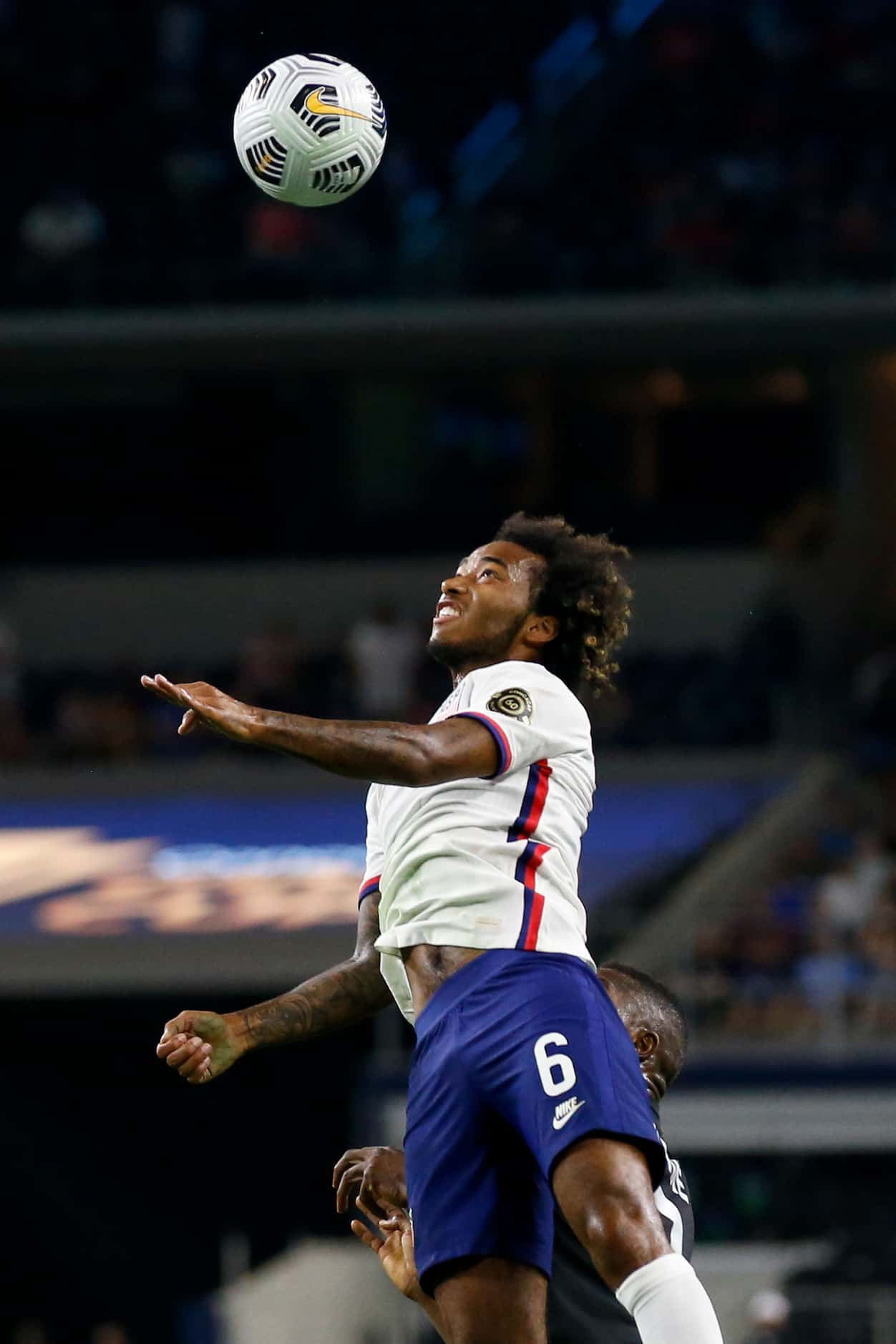 USA midfielder Gianluca Busio (6) leaps for a ball during the first half of a CONCACAF Gold...