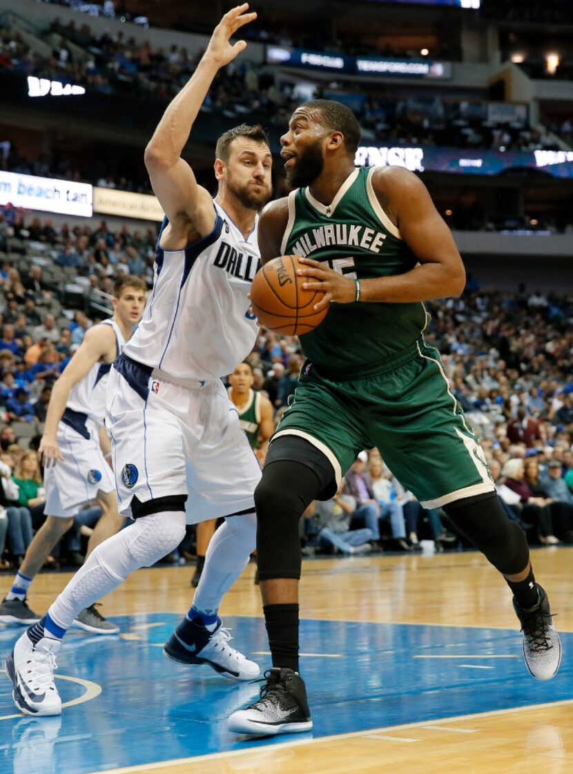 Dallas Mavericks' Andrew Bogut (6), of Australia, guards Milwaukee Bucks center Greg Monroe...