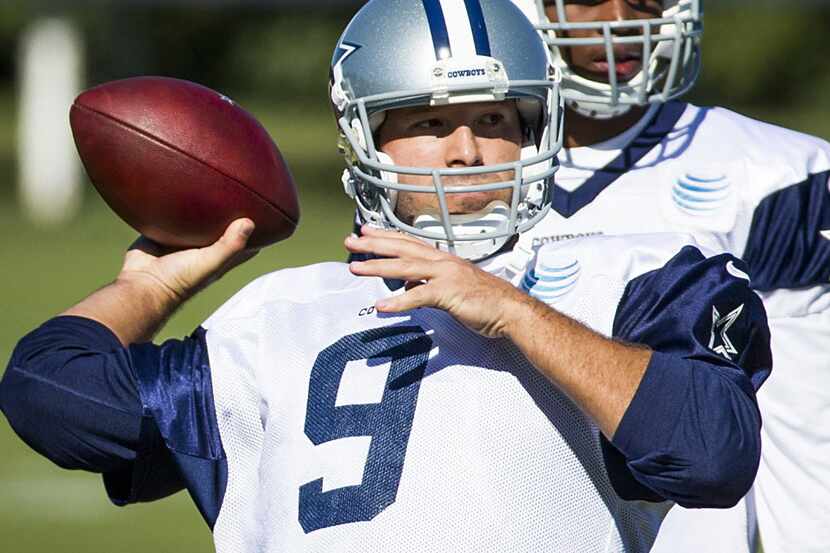 Dallas Cowboys quarterback Tony Romo throws a pass during practice at the team's facility at...