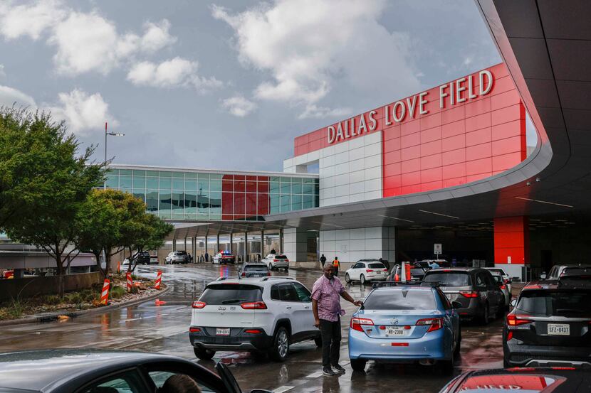 Motorists stop outside of Dallas Love Field airport to drop off travelers in Dallas, Friday,...