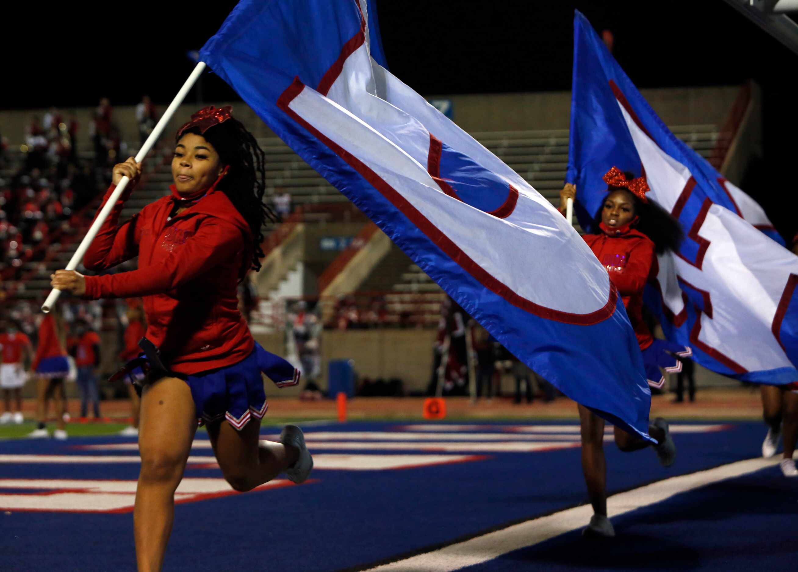 Duncanville Panthers flag wavers race across the end zone following a first quarter...