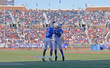 SMU wide receiver Derrick McFall (20) celebrates with his teammate SMU wide receiver Moochie...