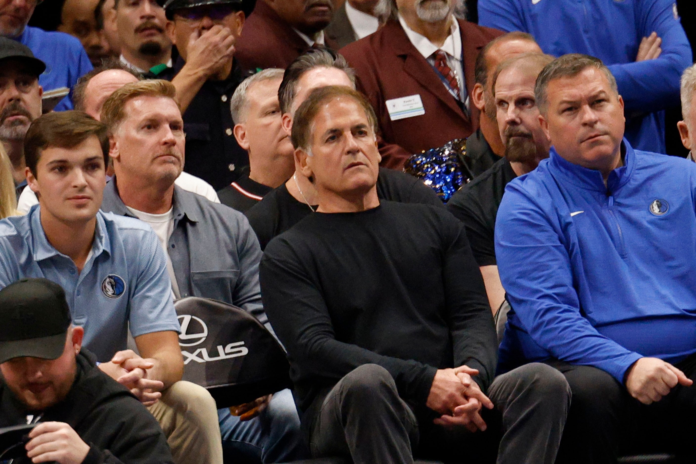 Dallas Mavericks minority owner Mark Cuban, center, watches an NBA basketball game between...