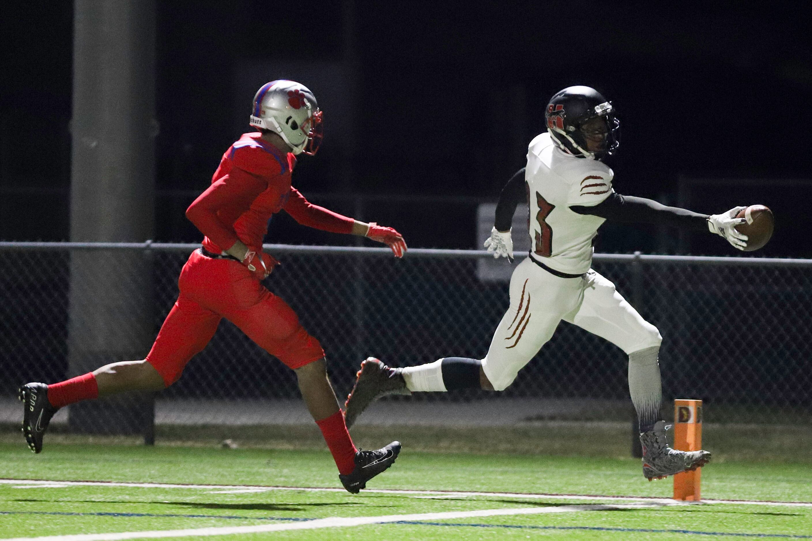 Hillcrest wide receiver Jakobi Hardy (23) stretches the ball across the goal line in front...