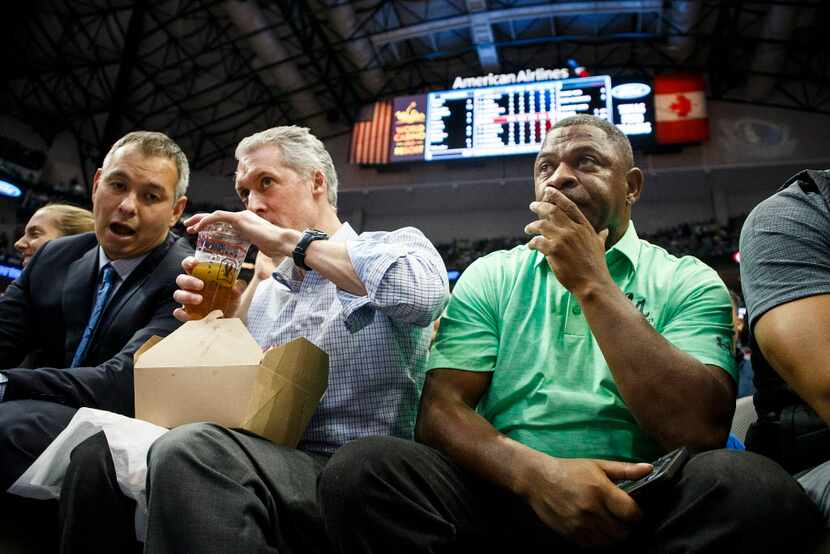 Dennis Smith Sr. (right) watches from seats along the baseline as his son, Dallas Mavericks...
