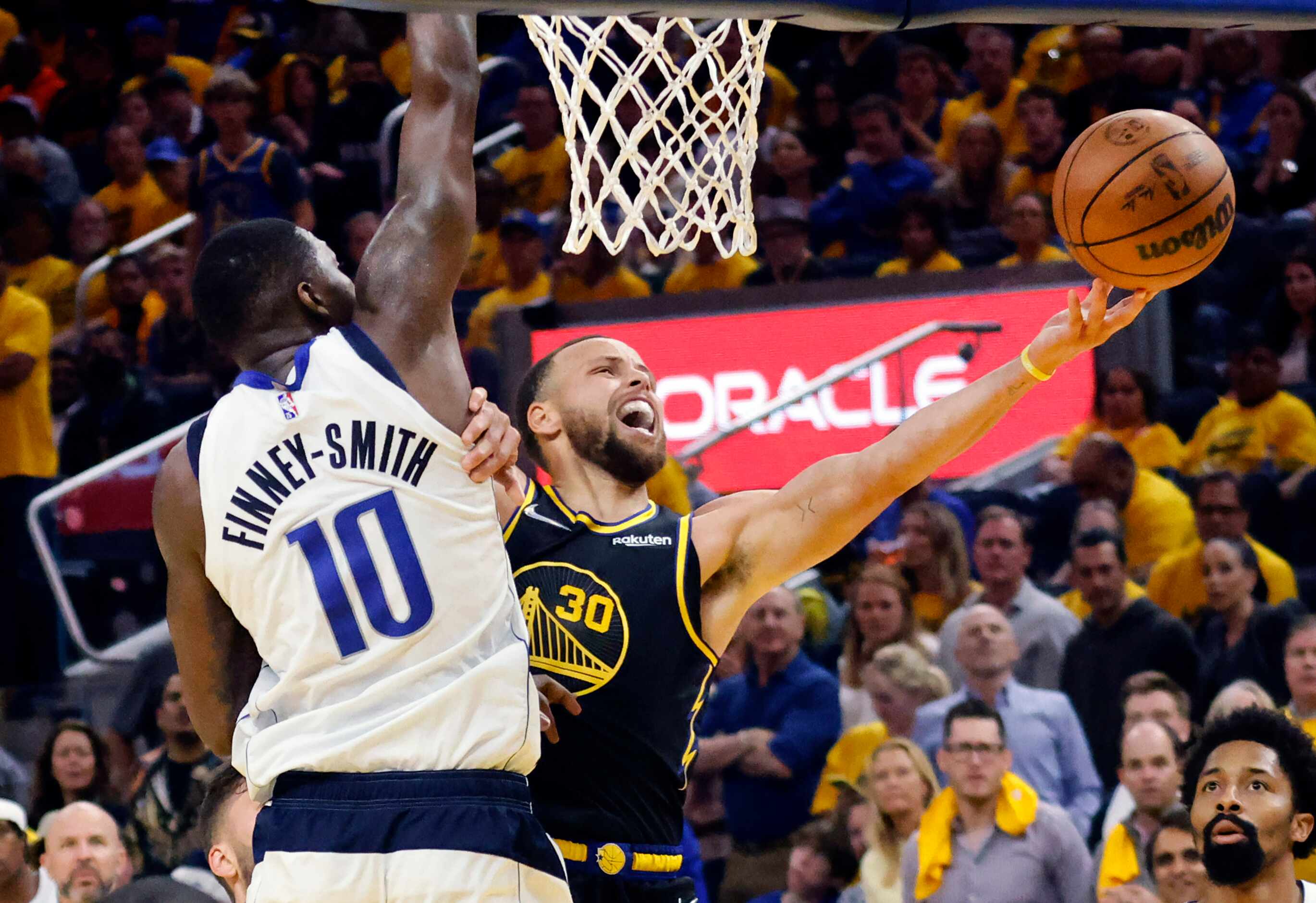 Golden State Warriors guard Stephen Curry (30) lays up a shot around Dallas Mavericks...