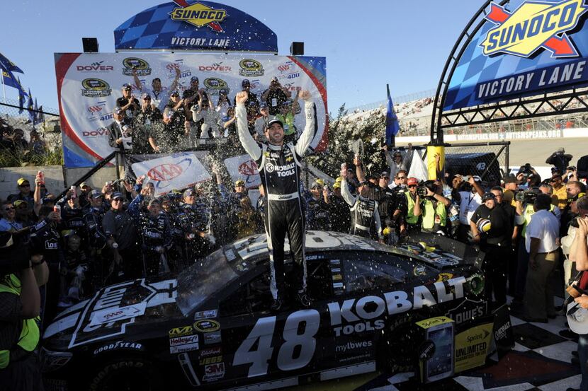 Jimmie Johnson poses for photographers in Victory Lane after he won the NASCAR Sprint Cup...