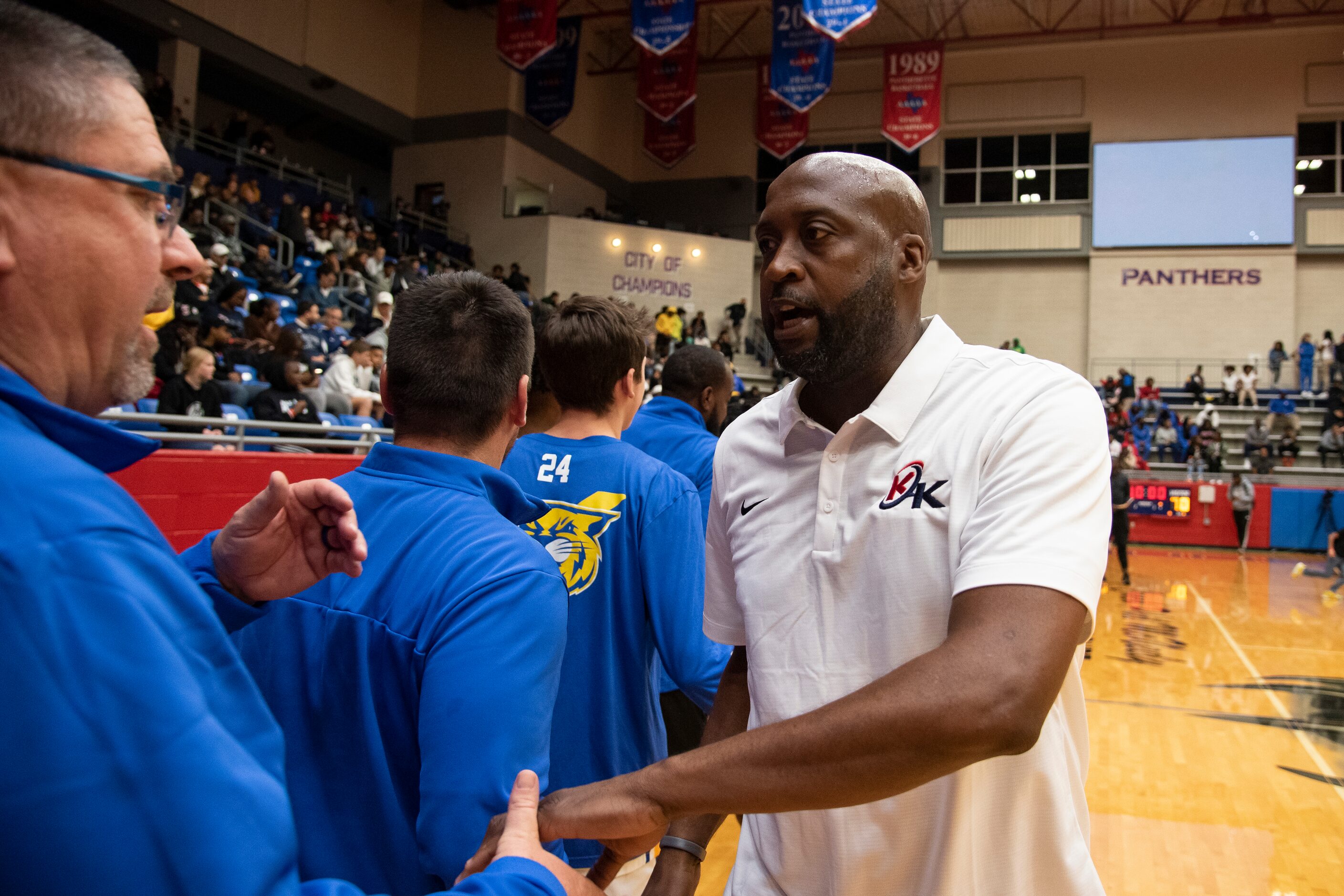 Kimball Head Coach Nick Smith shakes hands with North Little Rock Head Coach Johnny Rice...