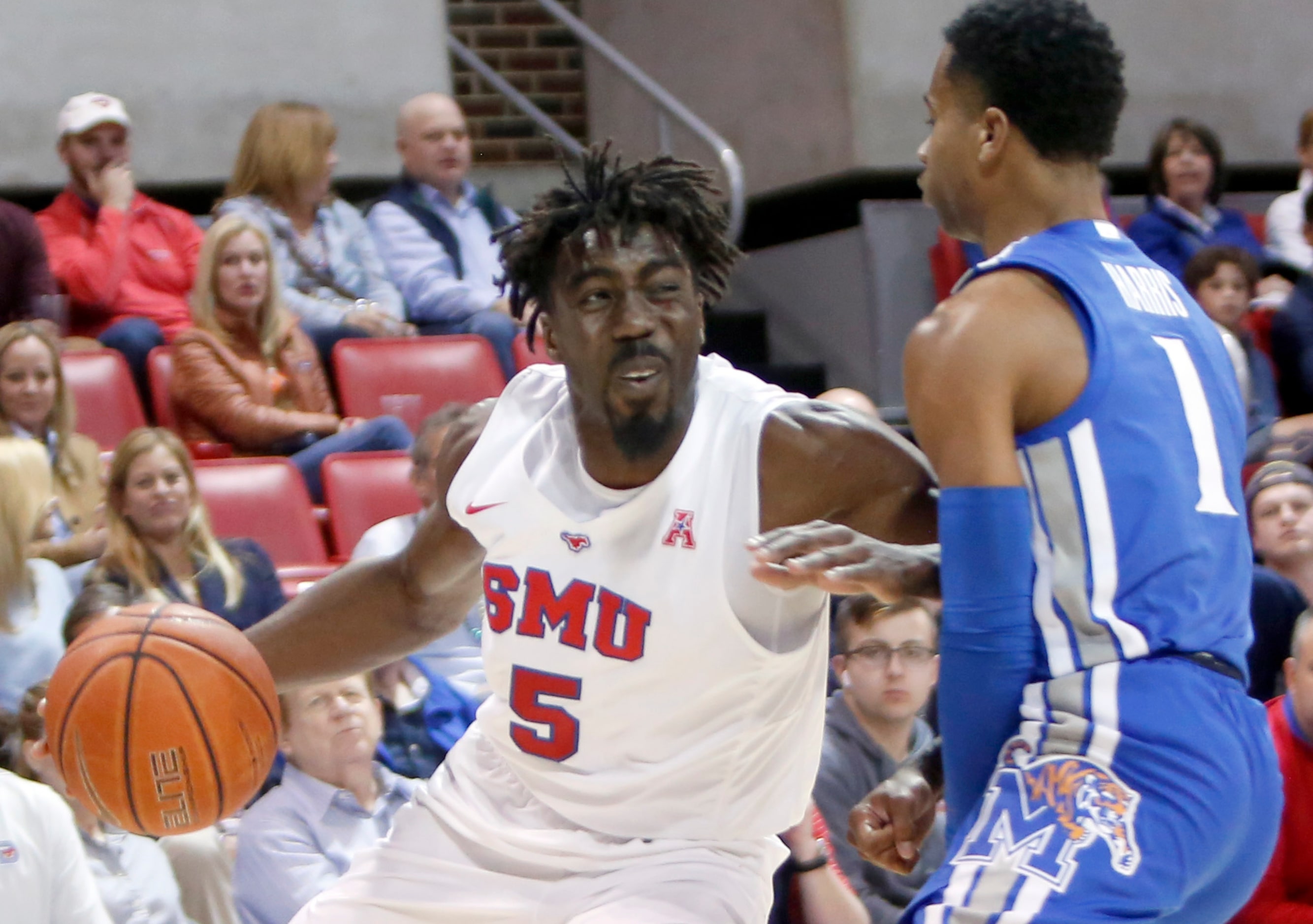 SMU guard Emmanuel Bandoumel (5) drives into Memphis guard Tyler Harris (1) during first...