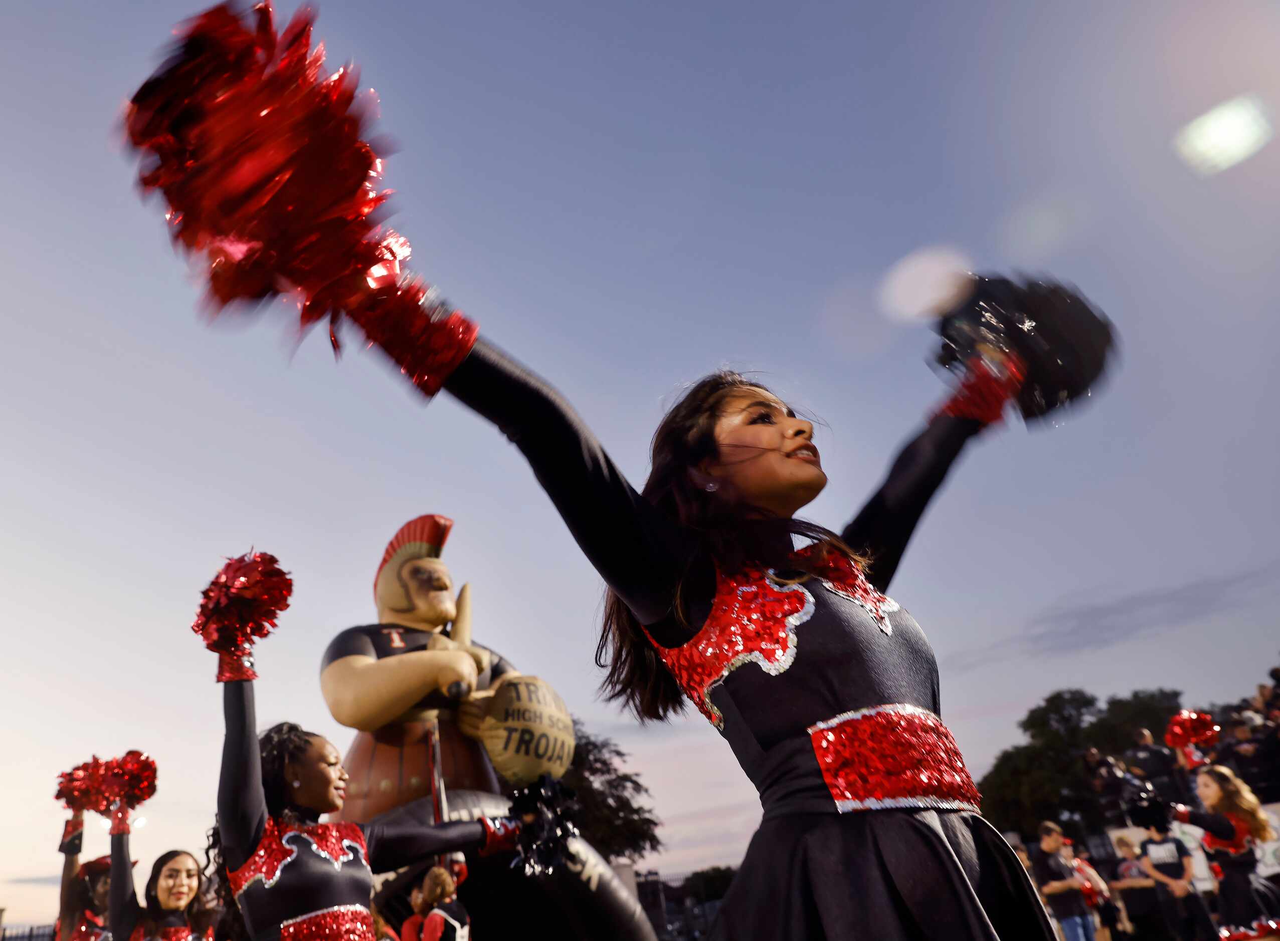 Trinity Troy-Anns member Ayzah Shah twirls her poms as the drill team waits for the team to...