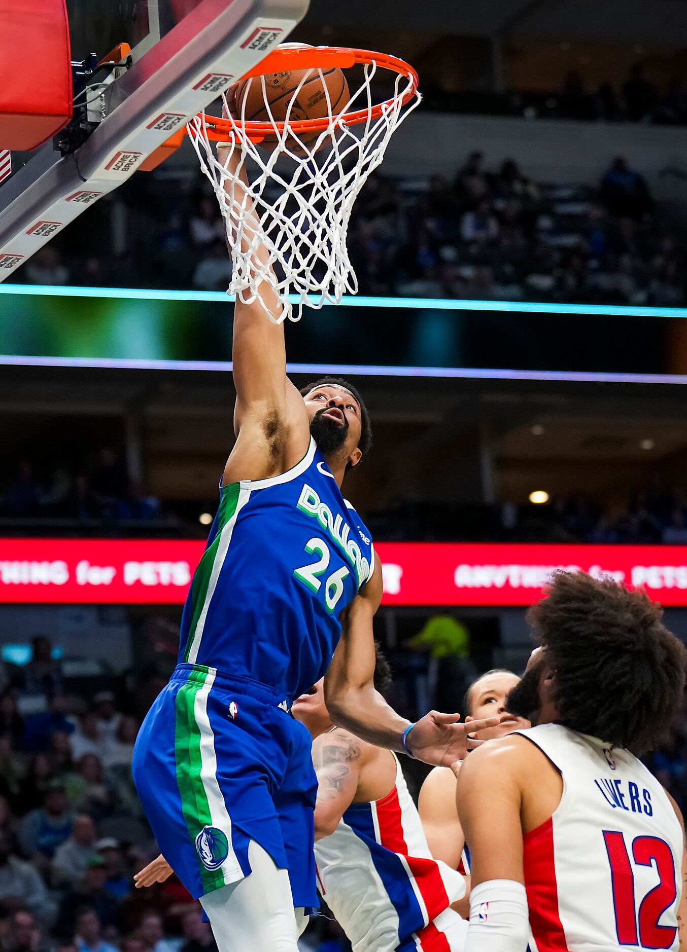 Dallas Mavericks guard Spencer Dinwiddie (26) dunks the ball over Detroit Pistons forward...