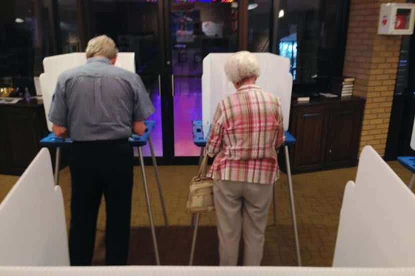 
Bob and Marcille McKelvy cast their vote at Zion Congregation Church in Dallas, in the...