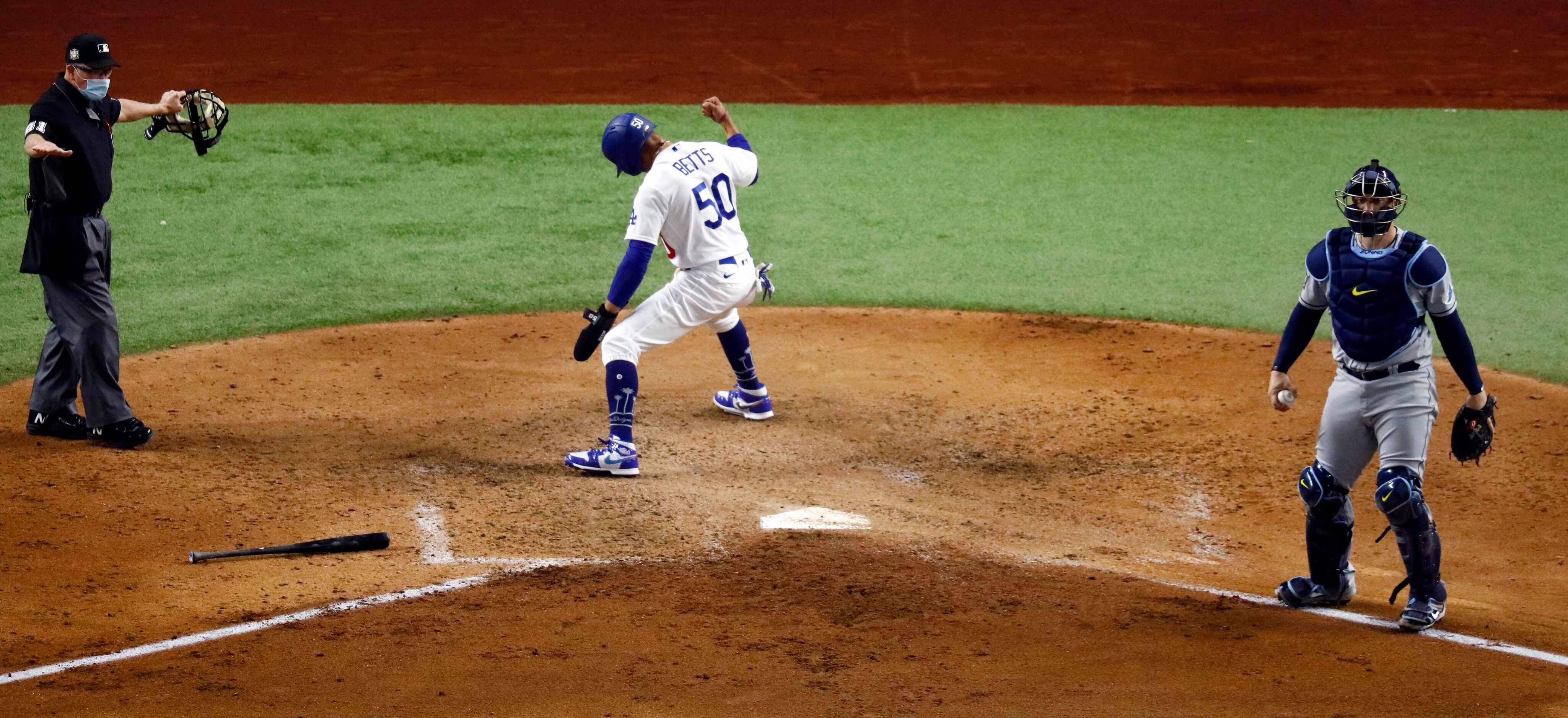 Los Angeles Dodgers Mookie Betts (50) celebrates after scoring a run on Tampa Bay Rays...