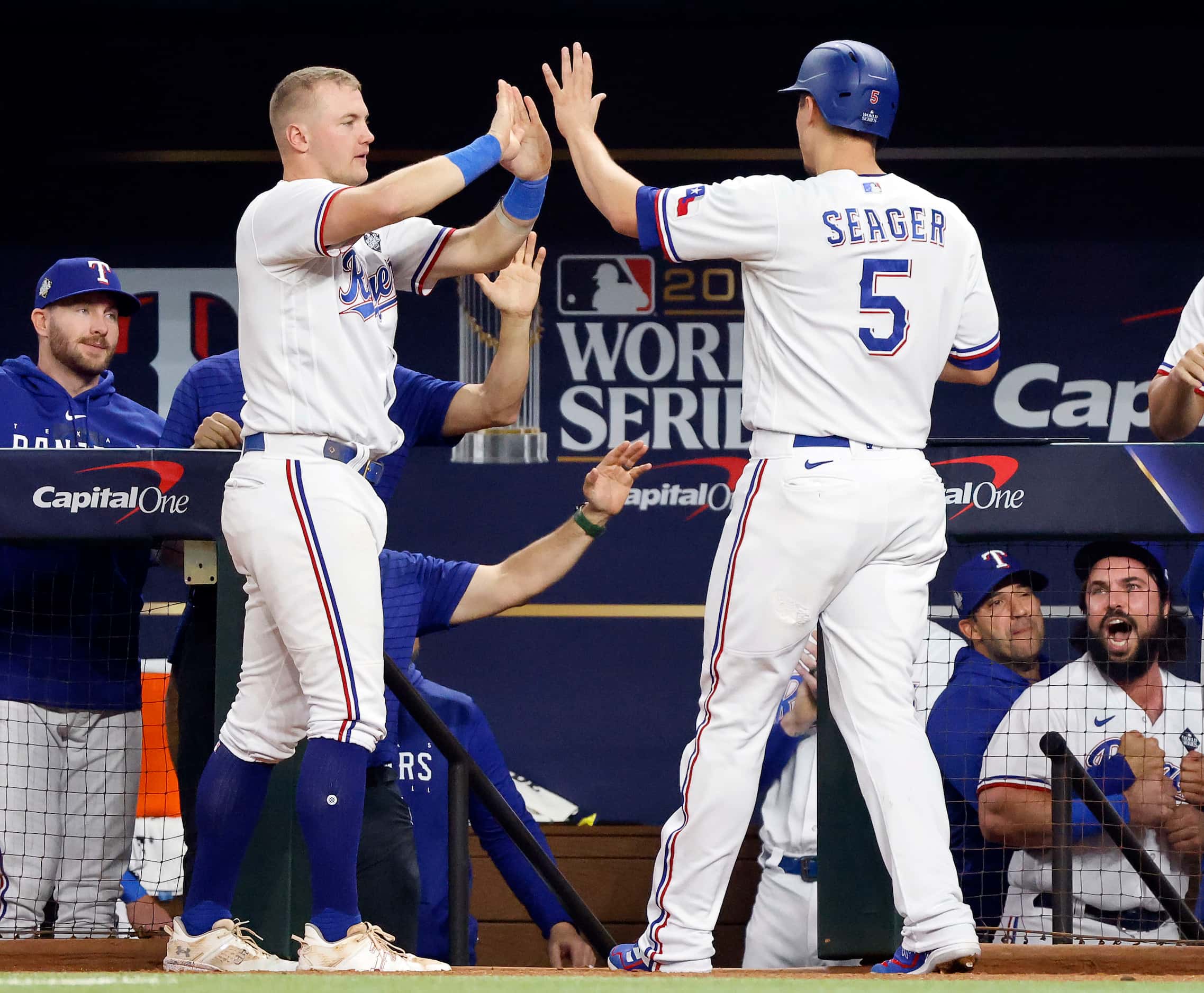 Texas Rangers third baseman Josh Jung (6) congratulates Corey Seager (5) who scored on a...