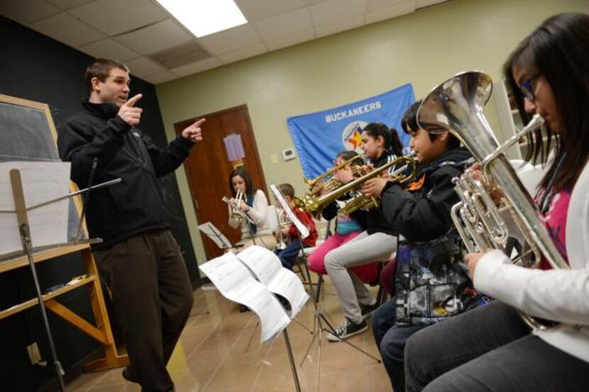 Josh Knapp, a volunteer and Irving school teacher, guides the beginning band class at the...