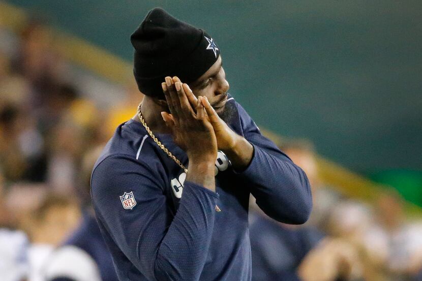 Injured Dallas Cowboys wide receiver Dez Bryant gestures after Dan Bailey's field goal as...
